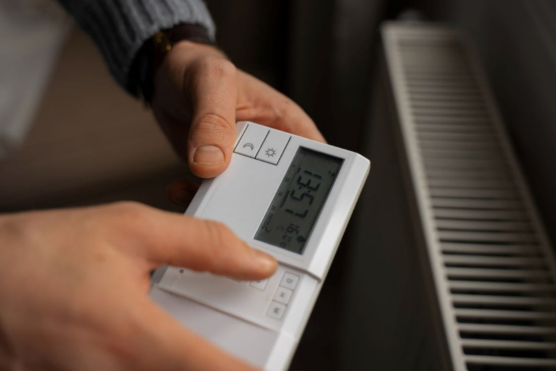 Professional installing a heat pump thermostat